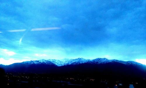 Scenic view of mountains against cloudy sky