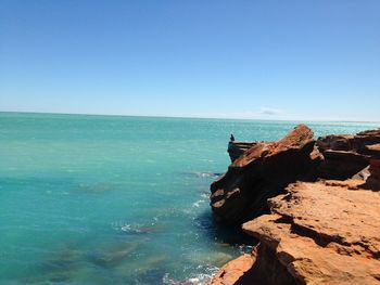 Scenic view of sea against clear blue sky