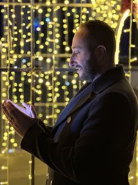 Rear view of man using mobile phone