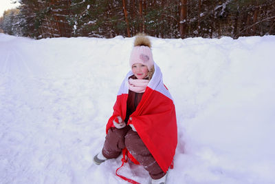 The girl is wrapped in the flag of canada