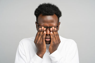 Portrait of young man against white background