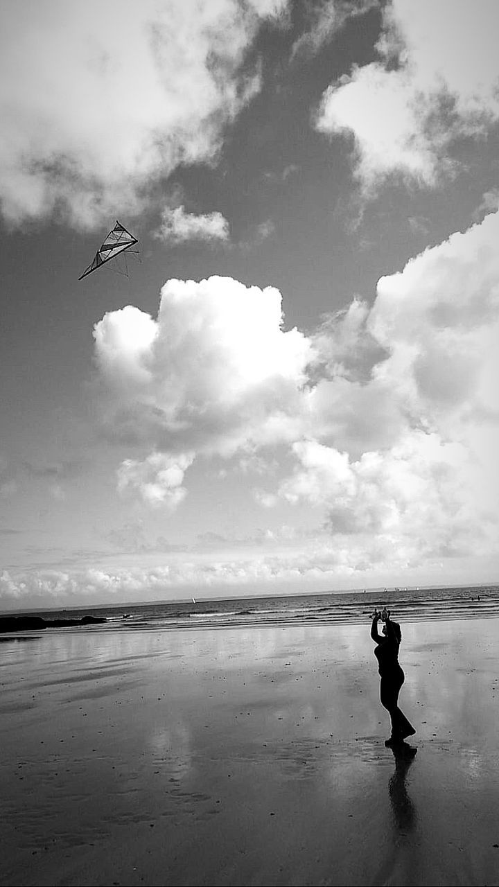 sky, water, cloud, black and white, white, sea, beach, monochrome, monochrome photography, nature, land, black, horizon, one person, full length, beauty in nature, wave, ocean, animal themes, day, men, animal, silhouette, child, childhood, bird, flying, leisure activity, outdoors, holiday, vacation, adult, standing, scenics - nature, trip, reflection, horizon over water, coast, tranquility, lifestyles