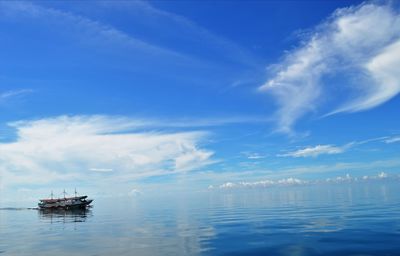 Fishing boat in sea against sky. 