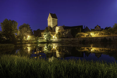 Reflection of building in lake at night