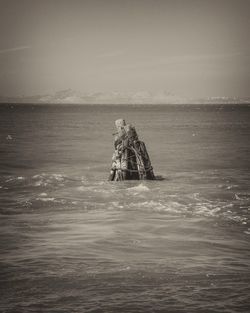 People on beach against sky