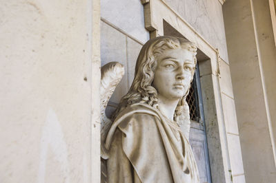 Angel statue by wall of church