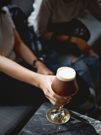 Midsection of woman holding coffee cup