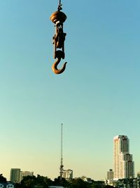 Low angle view of man jumping against clear sky
