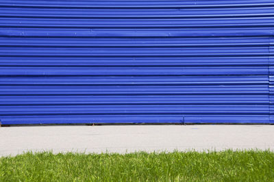 View of lawn against blue sky