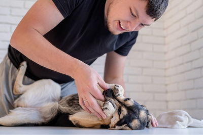 Midsection of man with dog