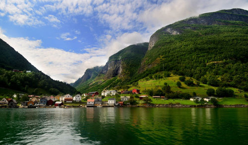 Scenic view of lake by mountains against sky