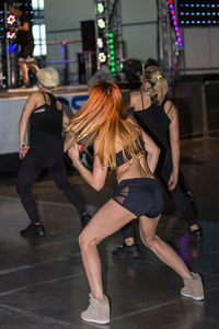 Women walking on street in city at night