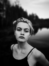 Portrait of young woman against blurred background