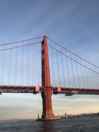 View of suspension bridge against cloudy sky