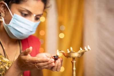 Midsection of man holding candles