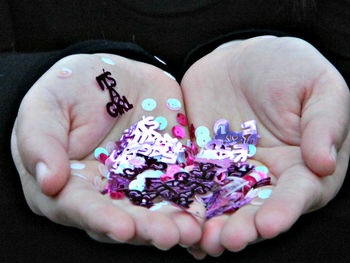 Cropped image of hand holding glass over white background