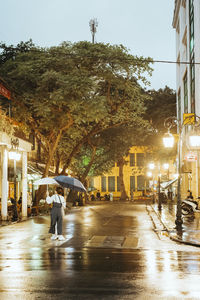 Man walking on wet street in rainy season