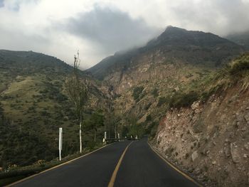 Empty road against mountains