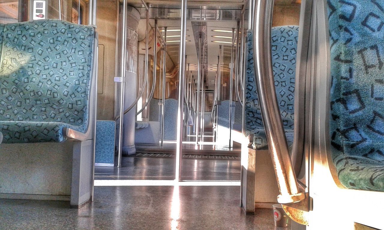 indoors, architecture, built structure, steps, metal, railing, steps and staircases, staircase, in a row, empty, reflection, no people, building, day, low angle view, modern, architectural column, window, sunlight, corridor