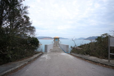 Road leading towards pier at high island reservoir