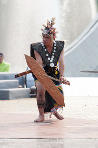 Full length of woman dancing on wood