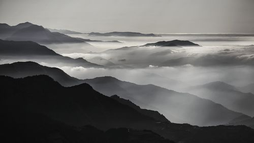 Scenic view of mountains against sky at dusk