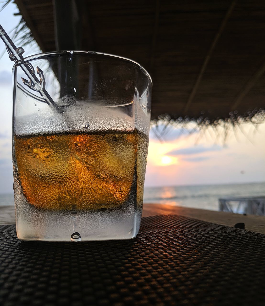 CLOSE-UP OF BEER GLASS ON TABLE