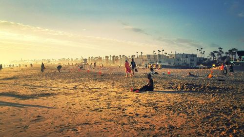 People on beach against sky