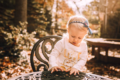 Close-up of cute girl sitting by table