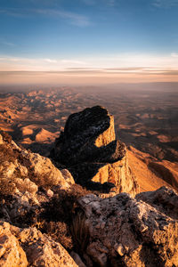 Scenic view of rock formation against sky during sunset