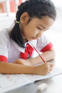 Boy sitting in pen