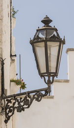 Low angle view of street light against sky