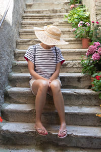 Full length rear view of woman walking on steps