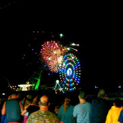People watching firework display at night