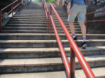 Low section of woman walking on staircase