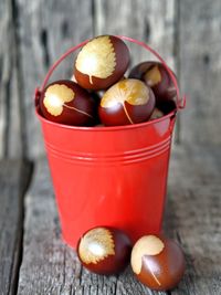 The concept of preparing for the easter holiday. painted eggs in a red bucket on a wooden 