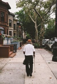 Rear view of people walking on footpath
