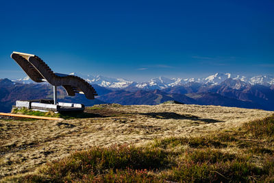 Scenic view of snowcapped mountains against clear blue sky