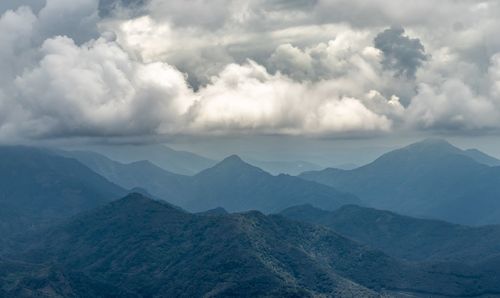 Hill layers with its shadow and white cloud