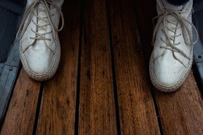 Low section of shoes on wooden floor