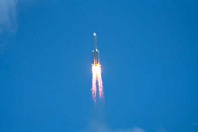 Low angle view of vapor trail against blue sky