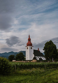 Church by tree against sky