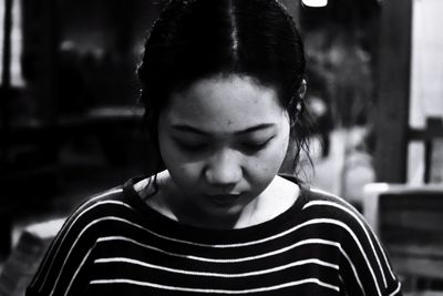 Close-up of young woman sitting at home