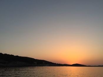 Scenic view of sea against clear sky during sunset