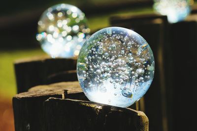 Close-up of glass balls on wooden posts