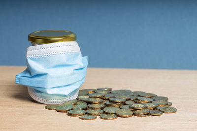 Close-up of coins on table against blue background
