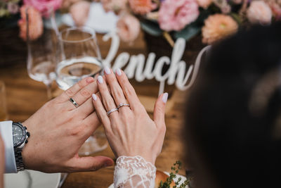 Midsection of couple holding hands