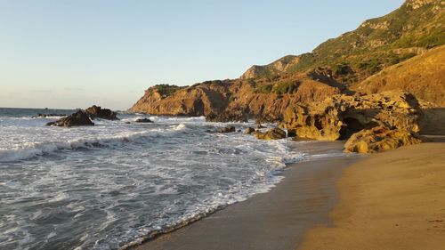 Scenic view of beach against clear sky