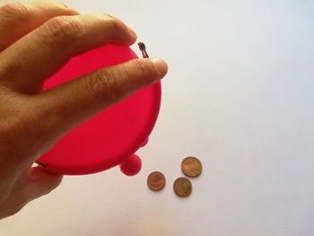 Close-up of hand holding coins