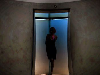 Man standing against window